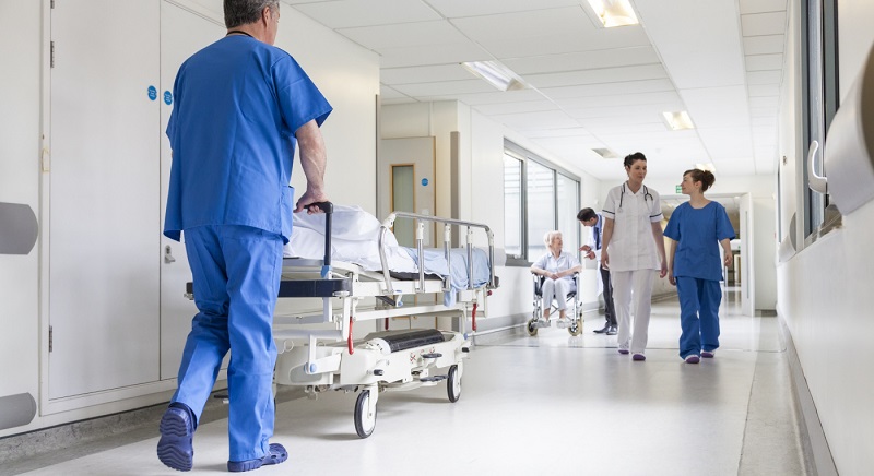 Doctors Hospital Corridor Nurse Pushing Gurney Stretcher Bed