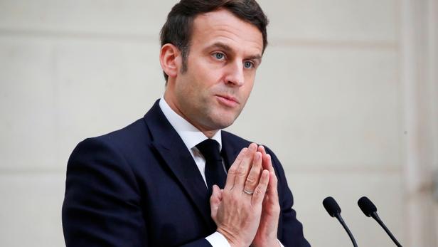 French President Emmanuel Macron delivers a speech to the French Bakery and Pastry Federation members next to the traditional epiphany cake, in Paris