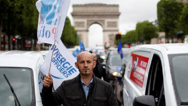 Police officers attend a demonstration in Paris