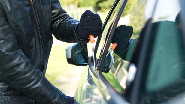 Thief stealing a car