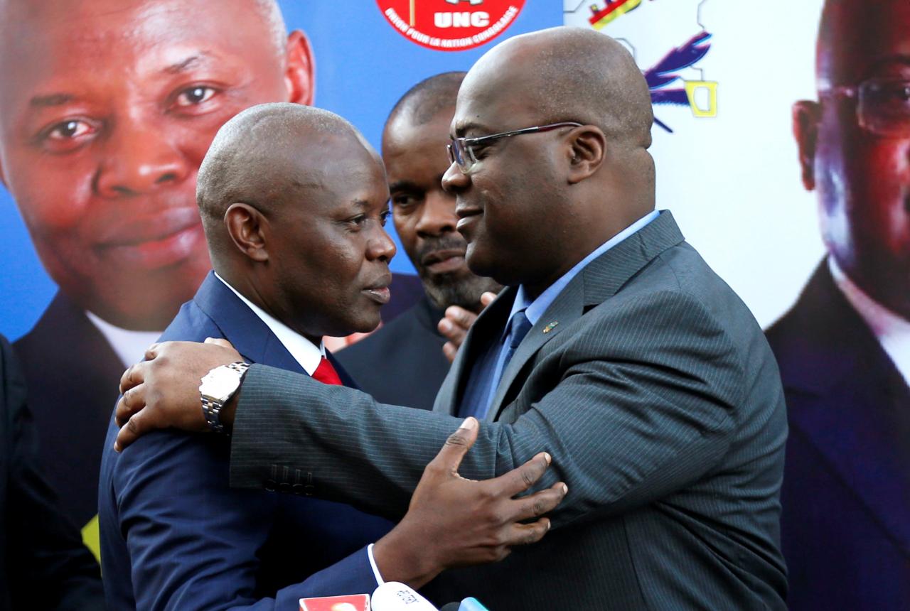 Vital Kamerhe, leader of the UNC party and Felix Tshisekedi, leader of Congolese main opposition, UDPS party, embrace at a news conference ahead of the Presidential elections in the Democratic Republic of Congo, in Nairobi