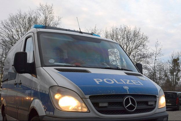 A police vehicle drives during a demonstration against government measures to curb the spread of the coronavirus disease (COVID-19) in Dresden, Germany, January 22, 2022. REUTERS/Matthias Rietschel