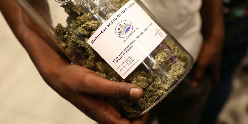 A man holds a jar full of cannabis buds before they were handed out by activist Steven Thapelo Khundu at the expo entrance, encouraging attendees to bring them inside, during the opening of the four-day expo in Pretoria, South Africa, December 13, 2018. REUTERS Siphiwe Sibeko