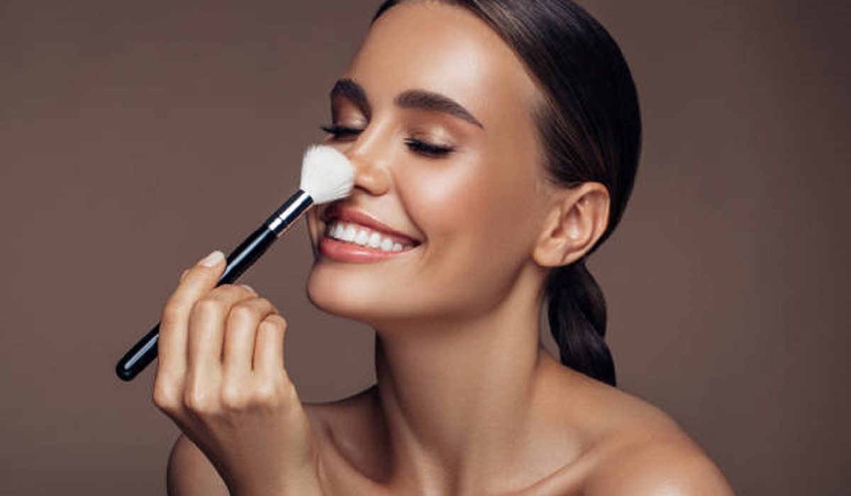 Beautiful woman applying make-up