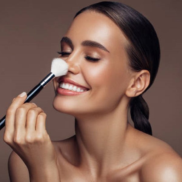 Beautiful woman applying make-up